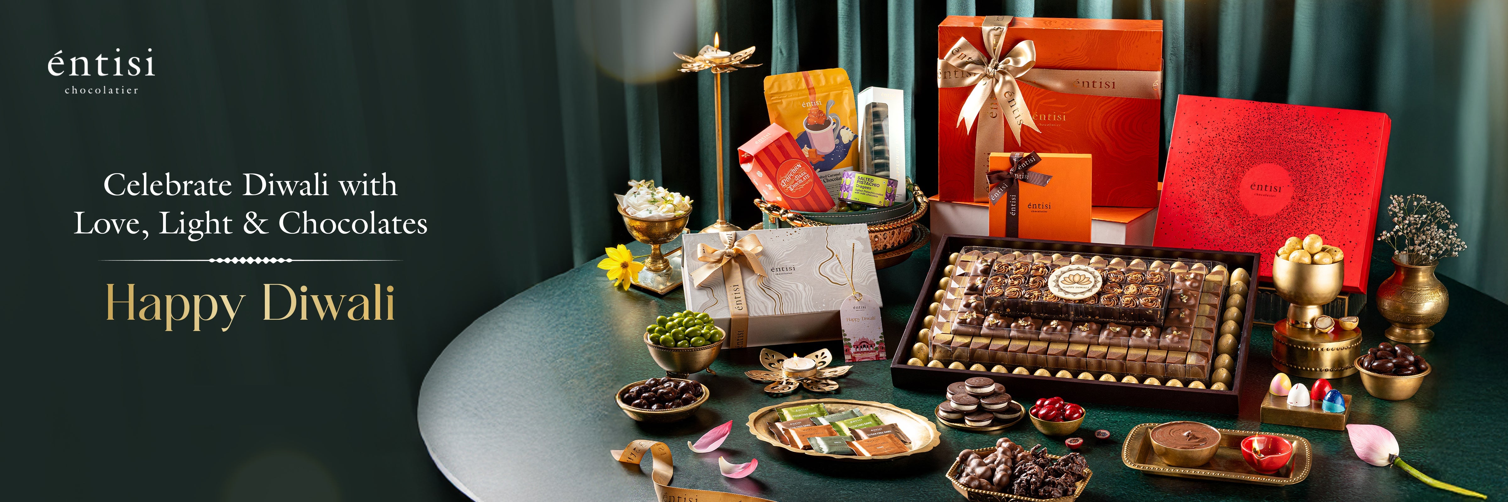 Diwali celebration with chocolates, gifts, and decorative items on a table.